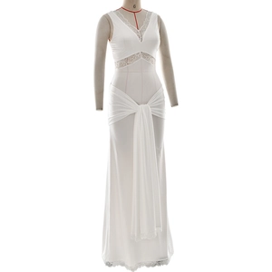 Close-up detail of white sleeveless V-neck dress with lace patchwork and knot draping