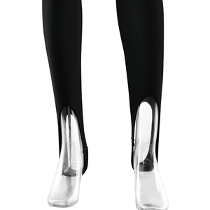 Detailed close-up of black stirrup leggings showing high-elasticity fabric and foot straps