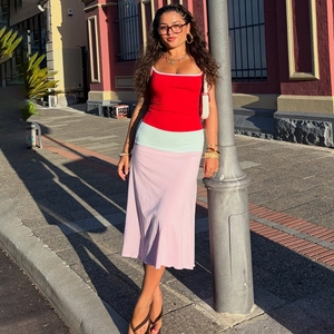 Detail view of the red slim fit camisole paired with a color-block midi patchwork dress