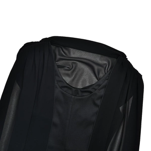 Detail of round neck black dress featuring sheer mesh patchwork and pleated shoulders