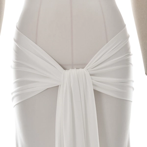 Detailed close-up of the elegant waist knot and draped white lace stitching fabric
