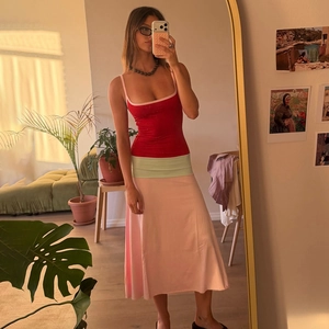 Detail view of the slim fit colorblock long dress with a red top and pink A-line skirt