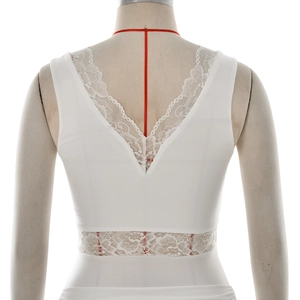 Detail of elegant white sleeveless dress with lace stitching on V-back and hollow waist