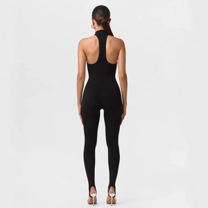 Sexy black backless halter jumpsuit with stirrup cuffs and a slim fit knitted design