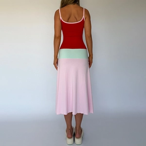 Rear view of color-block midi dress showing red back, green waist, and pink skirt