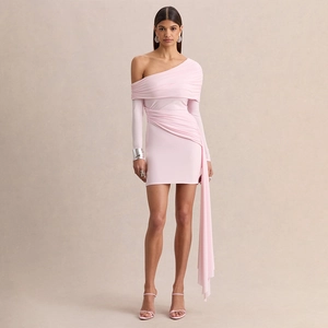 Detail of light pink mini dress featuring elegant side streamers and ruched fabric texture