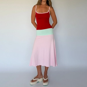 Detail of color-block knit maxi dress showing red top and mint green waist stitching