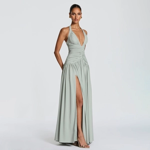 Detail of light sage green halter neck dress showing elegant pleats and high slit design