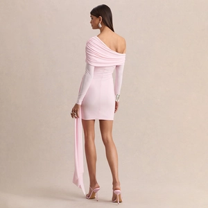 Detail view of pink bodycon dress featuring elegant shoulder ruching and a long sash