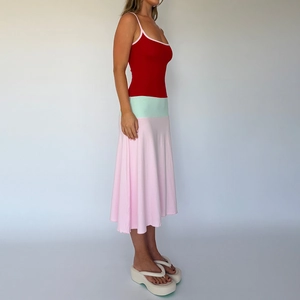 Detailed side view of slim fit dress featuring red straps, mint green waist and pink skirt