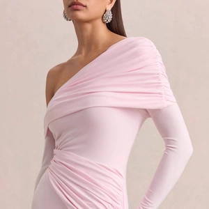 Detail of ruched fabric texture and asymmetric off-shoulder sleeve on a pink mini dress