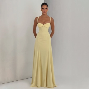 Detail of elegant cream yellow backless maxi dress with corset bodice and pleated waist
