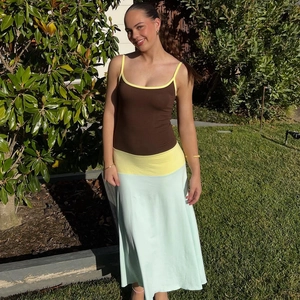 Detail of color-block knit maxi dress with brown, yellow and mint green panels