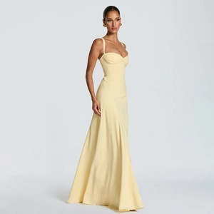 Close-up of elegant pale yellow long dress with thin straps and heart-shaped pleated neckline
