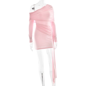 Detailed view of pink one-shoulder dress with elegant ruching and side ribbon details