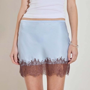 Close-up of light blue satin mini skirt with elegant dark brown eyelash lace trim