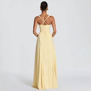 Elegant backless yellow maxi dress with crisscross straps and flowing pleated hem