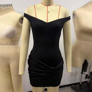 Detail of black off-the-shoulder mini dress featuring draped design and slim-fit texture
