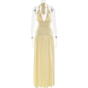 Detailed back view of a light yellow halter neck pleated dress with tie-up closure