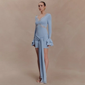 Detailed view of light blue lace patchwork V-neckline and elegant ribbon on the dress