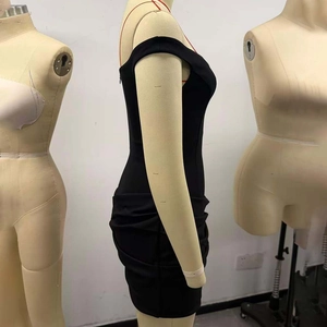 Detail view of black bodycon mini dress featuring side ruching and slim fit texture