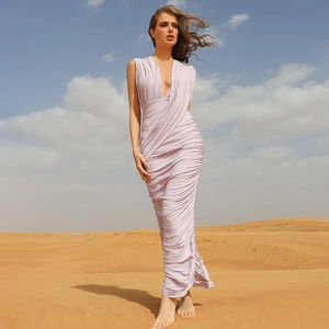 Detailed view of the ruched draping and slim fit of a lavender V-neck sleeveless dress