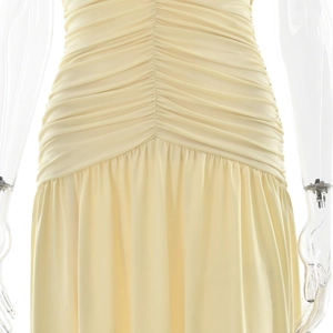 Detailed view of the elegant ruched waist design on this pale yellow sleeveless maxi dress