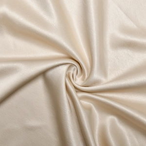 Detailed view of elegant champagne satin fabric with glossy finish and smooth texture