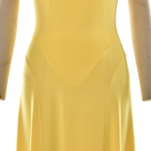 Close-up detail of the V-shaped waist seam on a bright yellow satin bodycon dress