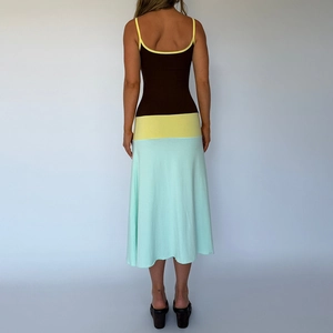 Detail of the backless design and three-color patchwork stitching on the knit maxi dress