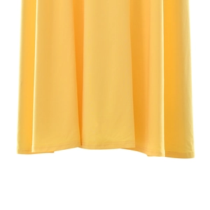 Detail shot of bright yellow pleated dress hem showing precision double-needle stitching