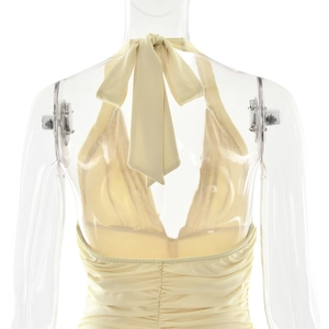 Detail view of the halter neck tie-back and ruched fabric on the yellow dress