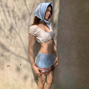 Side view of white puff sleeve crop top and blue mini skirt with vintage brown lace detail