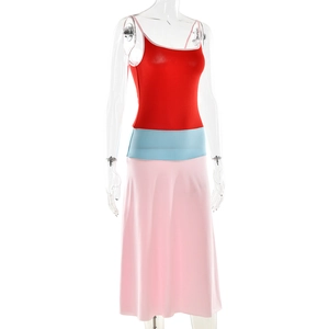 Detail of color-block dress showing red bodice, blue waist and pink A-line skirt