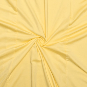 Detail of pale yellow pleated fabric with central spiral twist and delicate stitching