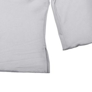 Macro shot of side split hem and precise stitching on a slim light gray knitted t-shirt
