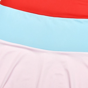 Detail of color-block stitching in red, blue, and pink on a slim fit maxi dress