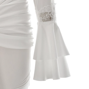 Detailed view of the elegant white lace patchwork and layered ruffles on the sleeve cuff