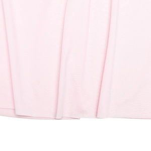 Detailed macro view of light pink knit fabric showing soft texture and bottom hem draping