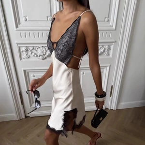 Elegant white satin dress with black lace V-neck and stylish side cut-outs for women