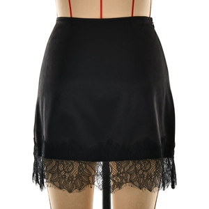 Detail of black satin mini skirt featuring delicate eyelash lace trim and silk finish