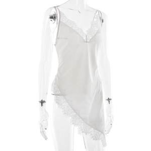 Detail of white satin dress with intricate floral lace trim and asymmetric hemline