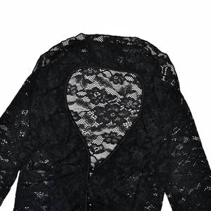 Detail of black lace top with V-neckline, floral texture, ruffles, and button accents
