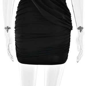 Detailed view of black ruched bodycon dress showing elastic fabric and side drape
