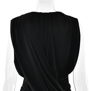 Detailed view of black ruched fabric texture and back draping on a slim fit dress