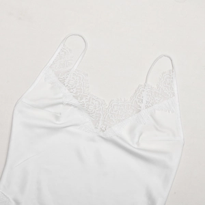 Detail of white silk camisole with delicate eyelash lace trim and thin straps