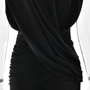 Close-up of ruched draping details on the back of a black V-neck bodycon dress