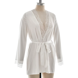 Detailed close-up of white satin robe with delicate lace trimming and waist tie