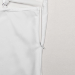 Detail of white dress showing side invisible zipper and strap with metal ring connector