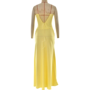 Détail de la robe longue jaune dos nu avec des brides rouges croisées et une coupe ajustée